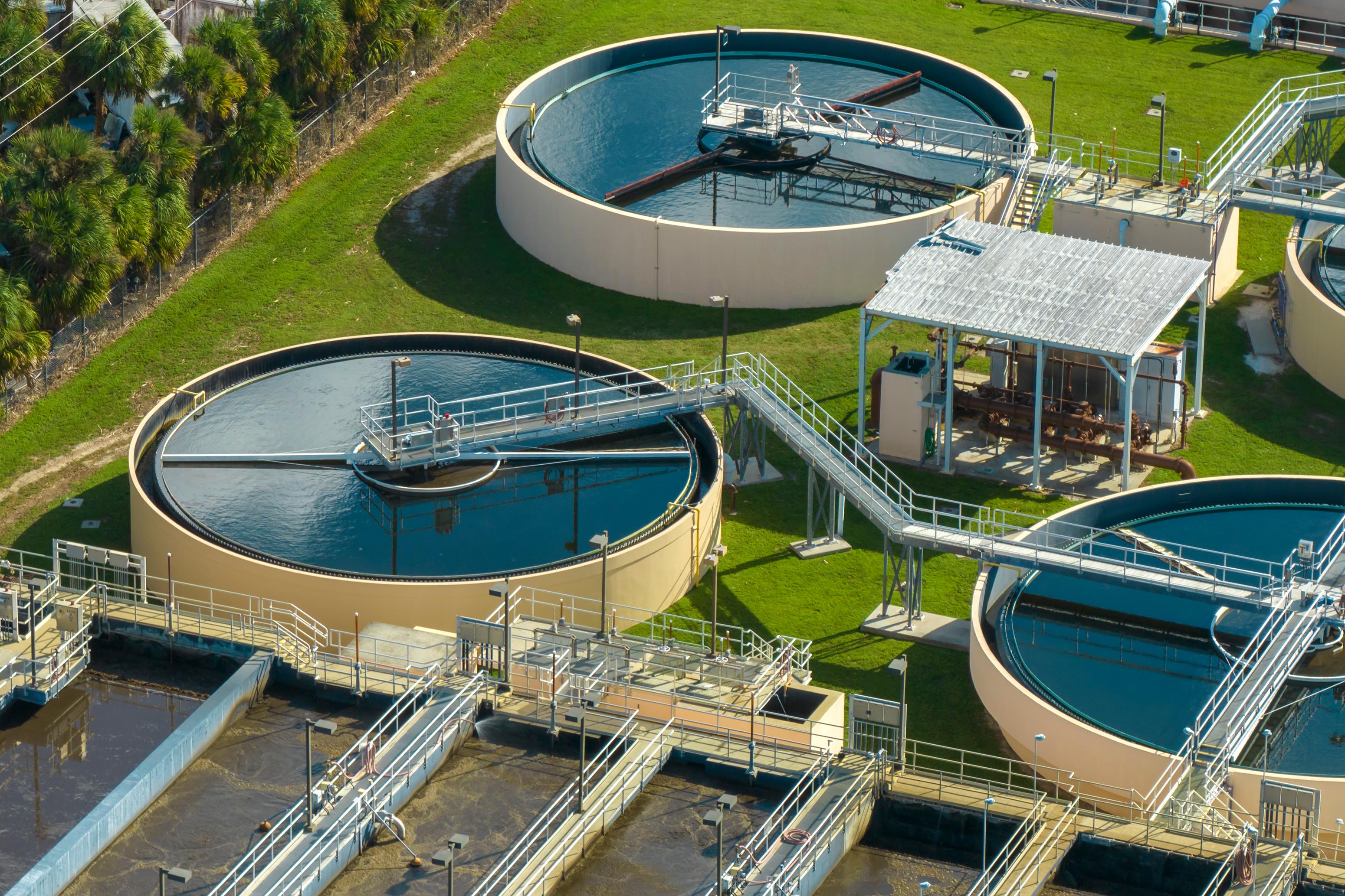 Aerial view of modern water cleaning facility at urban wastewater treatment plant. Purification process of removing undesirable chemicals, suspended solids and gases from contaminated liquid.